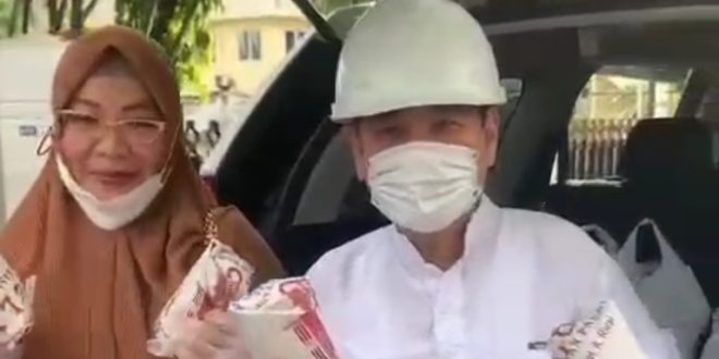 Anggota DPRD Sumsel, Chairul S. Matdiah, bersama istri, saat membagikan Nasi Bungkus. (bekisarmedia.id/sikumbang hasan)
