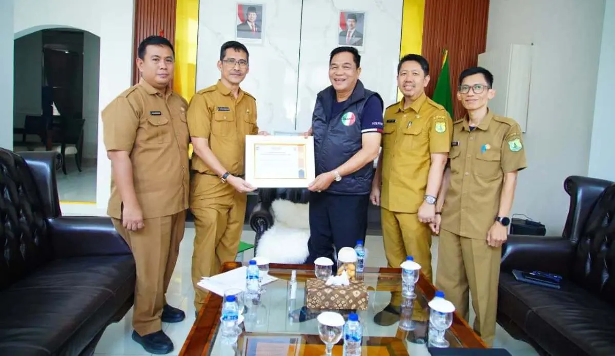Ir. H. Pathi Riduan, S.E., A.T.D., M.M., I.P.P., secara resmi menyerahkan piagam penghargaan Indeks Keinsinyuran Daerah (IKD) Tahun 2026 kepada Bupati Muba, Toha Tohet. (FOTO : BEKISARMEDIA.ID/TRI)